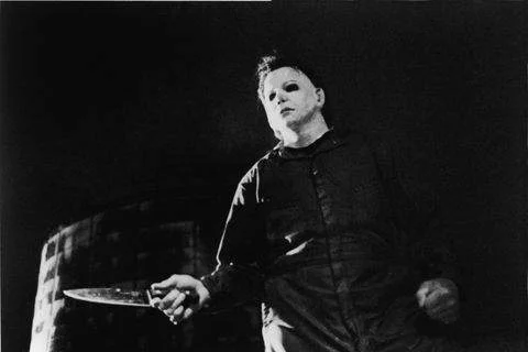 actor-tony-moran-as-masked-kiler-michael-myers-wields-a-news-photo-51044765-1562854778.webp