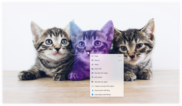 Image of three kittens sitting on a wooden surface with a computer context menu overlaid on the center kitten. The context menu includes options like Copy, Paste, and Properties, along with other options like “Ask Copilot”.
